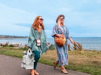 Two women walking along waterfront
