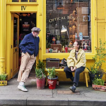 Man and woman talking outside shop