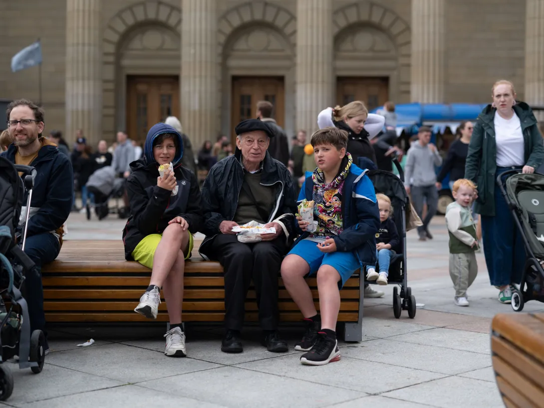 Man and boys eating