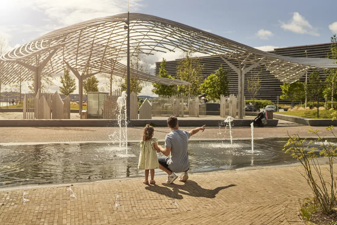 Dad & daughter at water fountains at Dundee Waterfront